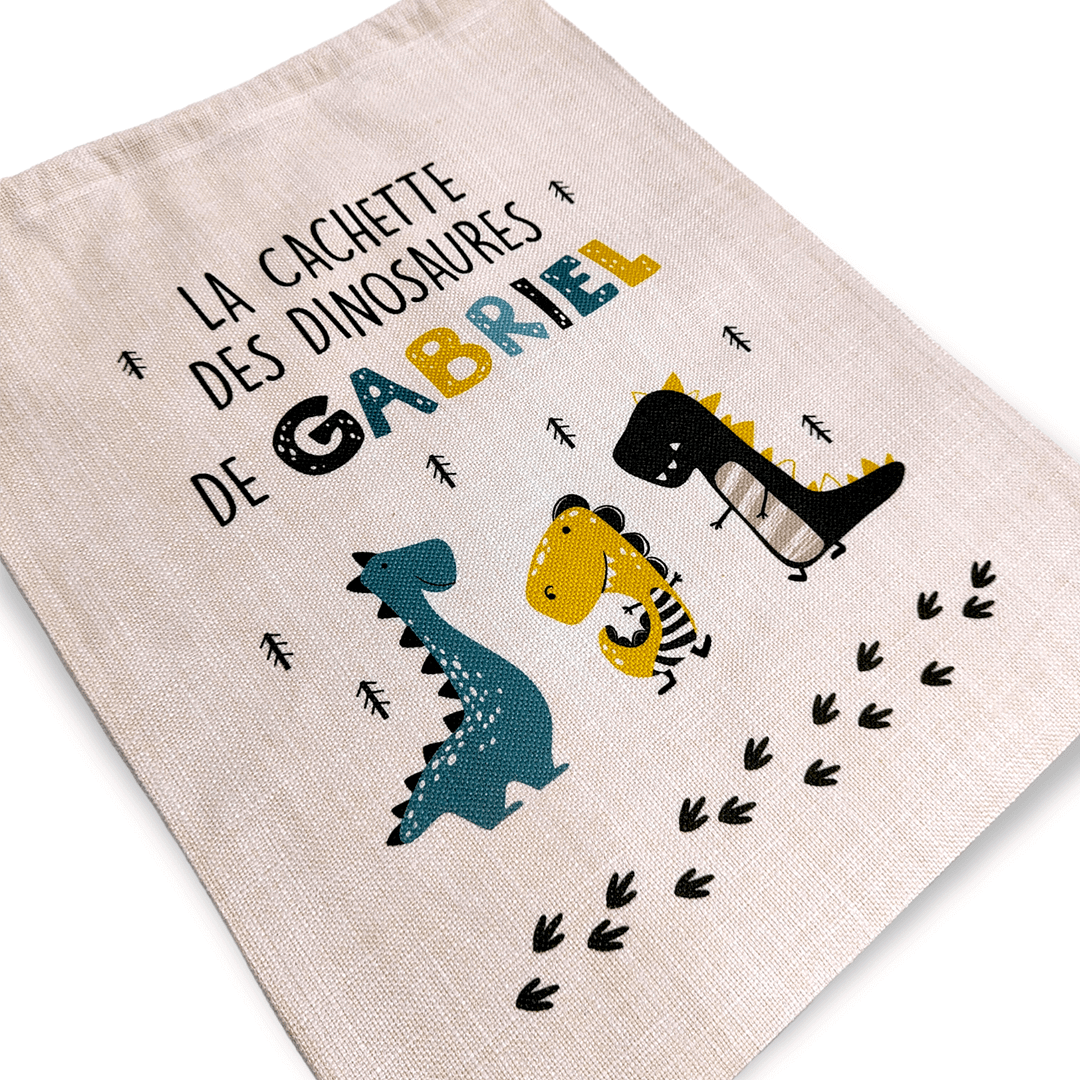 Sac à jouets pour enfant sur le thème des dinosaures. Pour une chambre bien rangée. Personnalisable au prénom de votre enfant.